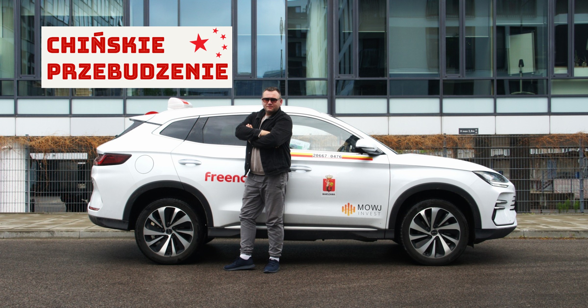 Taksówkarz Marcin Zawodzian na tle swojego chińskiego SUV-a marki BYD