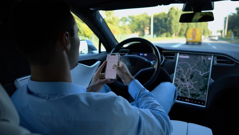 Kierowca z telefonem  - zdjęcie ilustracyjne