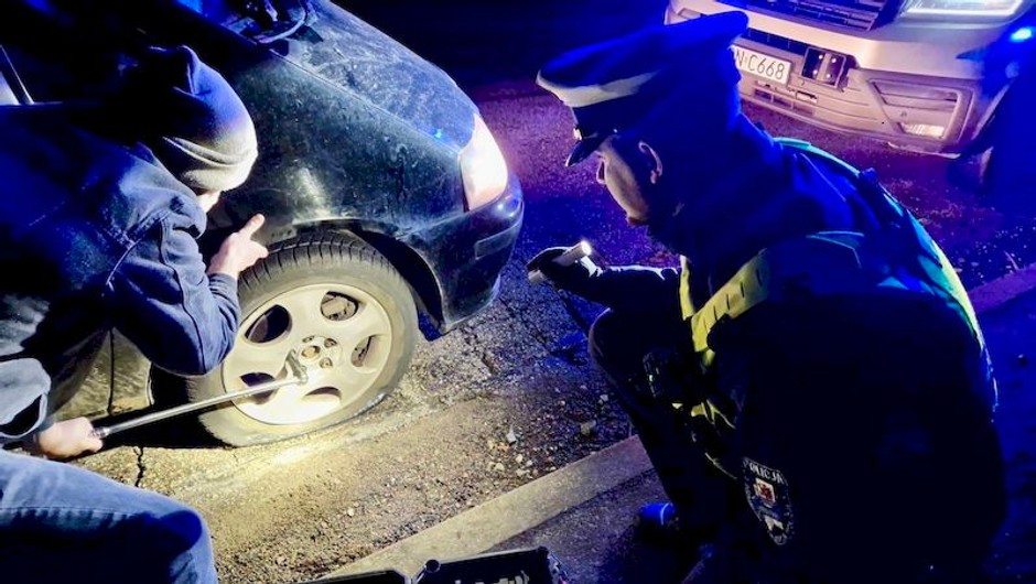 Policjanci pomagają kierowcom po uszkodzeniu kół na zniszczonej drodze