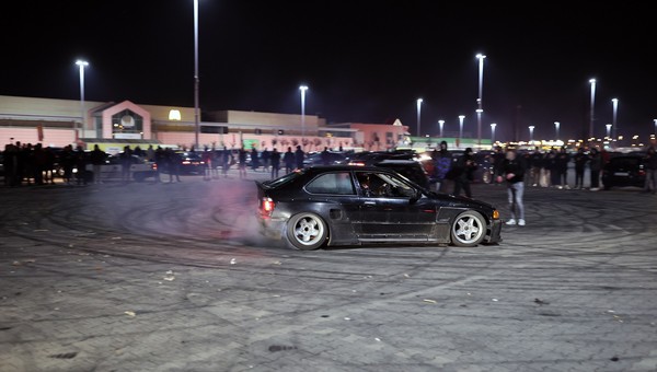 Nielegalny zlot samochodowy. Drift na parkingu pod supermarketem