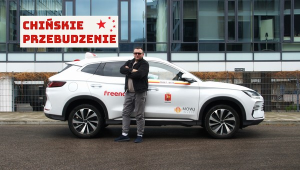 Taksówkarz Marcin Zawodzian na tle swojego chińskiego SUV-a marki BYD
