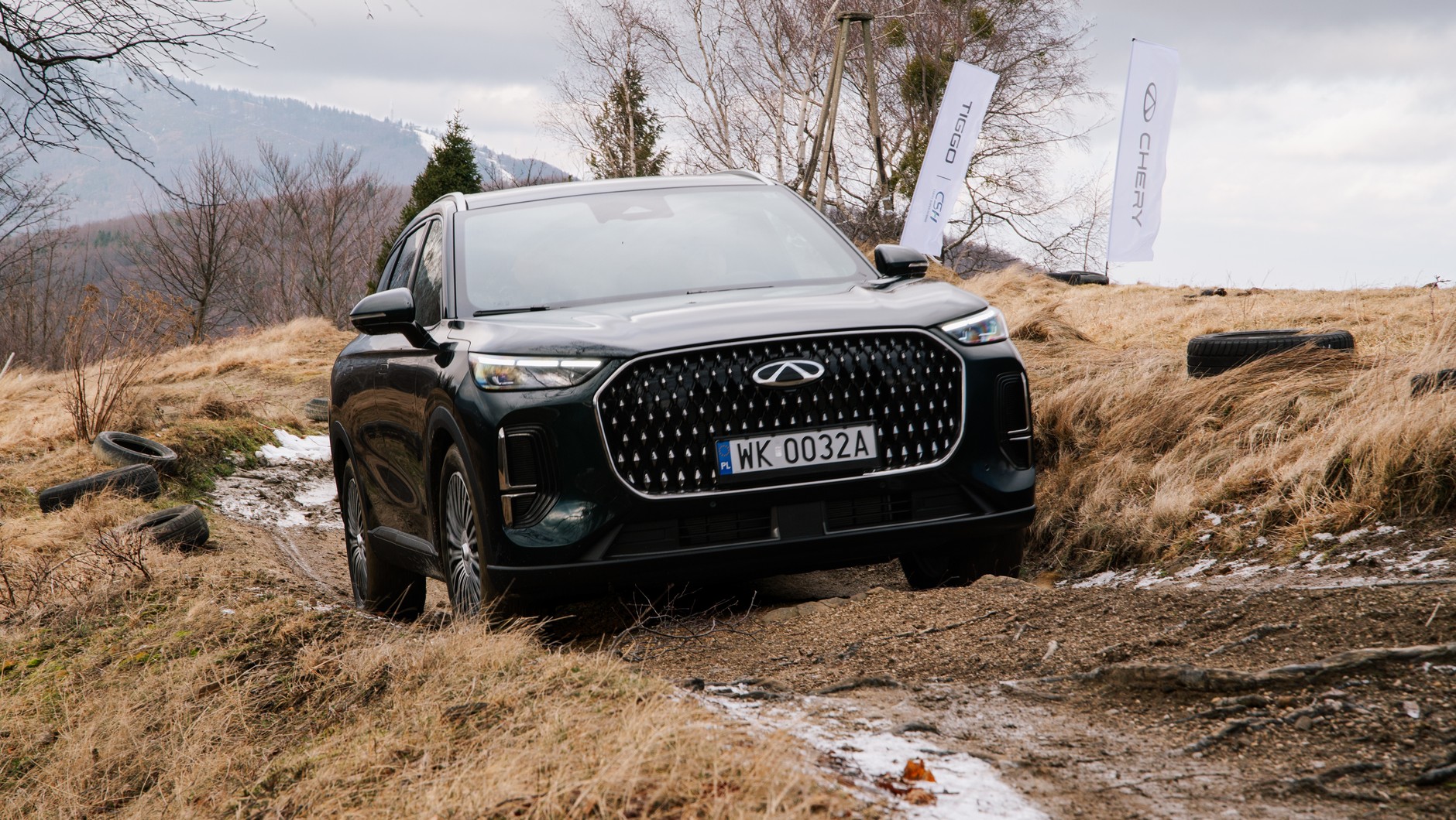 Chery Tiggo 9 nieźle radzi sobie na nieutwardzonych drogach, choć prześwit wynoszący 181 mm nie pozwala na pokonywanie poważniejszych przeszkód. W trybie terenowym napęd sprawnie rozdziela moment obrotowy między obie osie, a silnik spalinowy pracuje przez cały czas. 