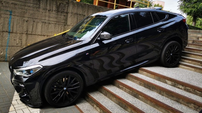 Czarne BMW X6, które zawisło na schodach w Chorzowie