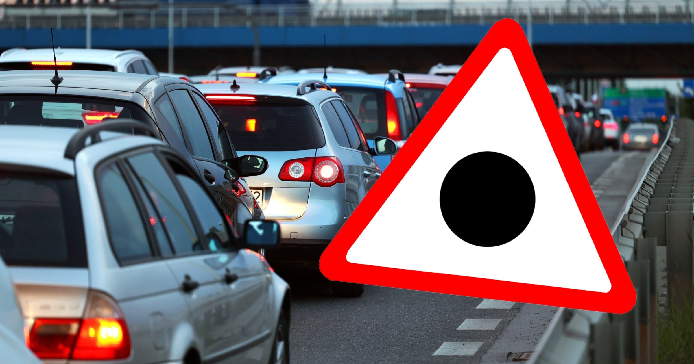 Znak drogowy przedstawiający czarną kropkę wpisaną w trójkąt ostrzegawczy